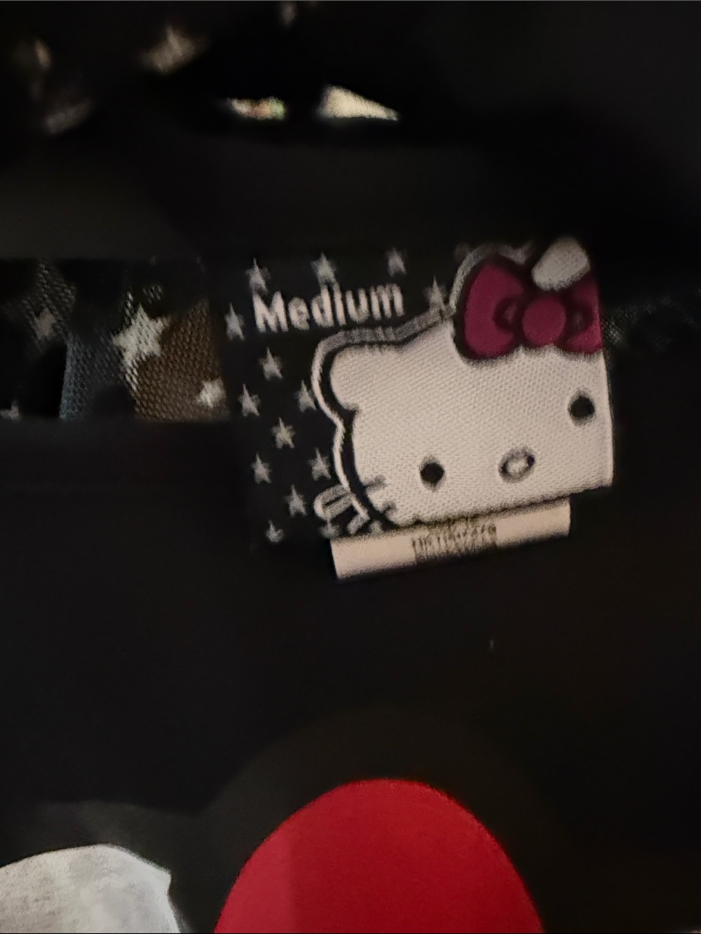 NWOT Hello Kitty Sanrio Black Star Print High-Low Top w/ Sheer Back & Bow - M - Picture 3 of 3